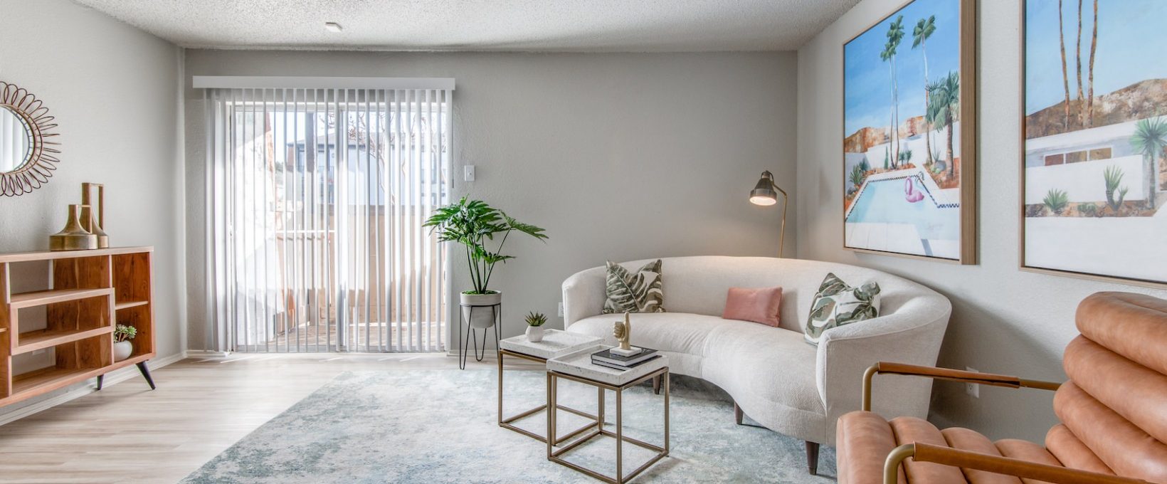 a living room with a couch, coffee table and a painting at The 8500 Harwood