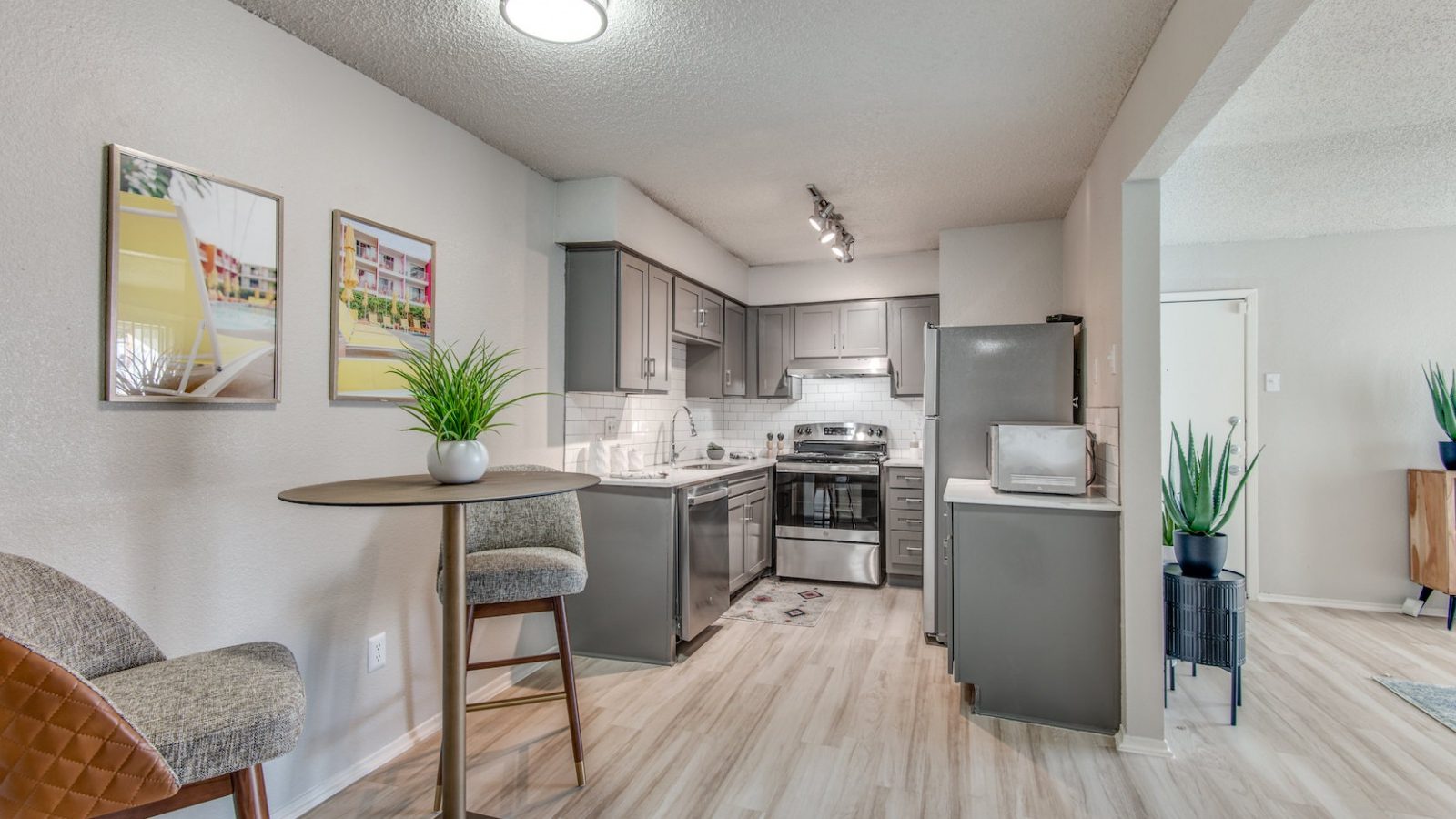 a kitchen with a dining table and chairs in it at The 8500 Harwood
